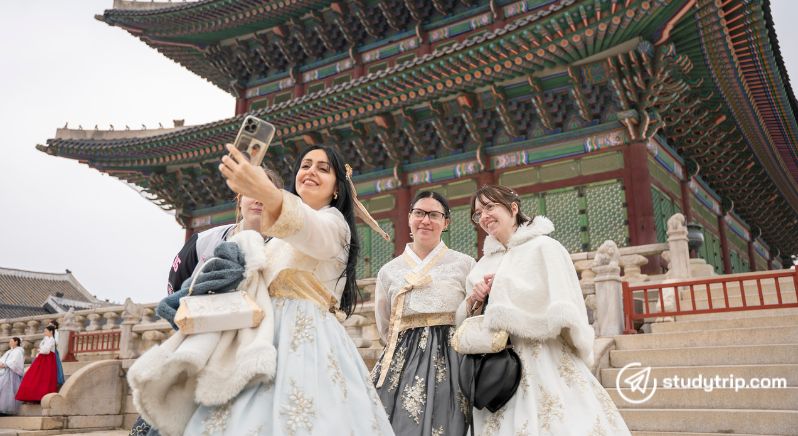 students in hanbok taking a selfie